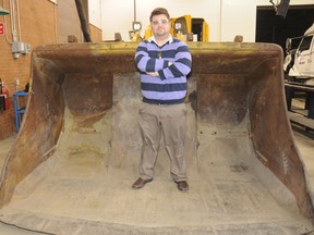 Stephen Gravel, applied research developer, industrial planning and research, at Cambrian College, stands next to a scoop tram.
GINO DONATO The Sudbury Star