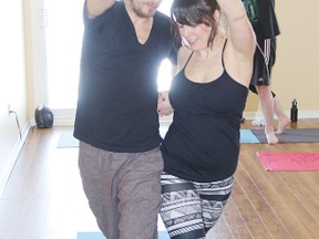STEPHEN UHLER     Peter and Shannon MacLaggan, owners of the White Pine Yoga Studio, demonstrate some of the exercises one can do with their partner during a yoga seminar held recently. This is the first time the studio had held such a session, and it proved to be popular.