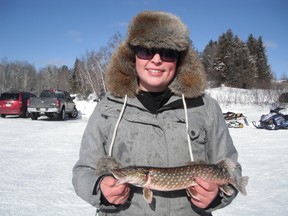 JOHN VANCE For The Sudbury Star 
Ardent Northern fisher Ashtin Muldoon, of both Sudbury and Spanish, smiles heartily with her first fish of the day, a small northern pike that she entered at one of several fishing derbies held on Free Family Fishing Weekend last weekend.