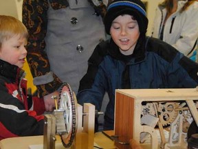 At left Tristan Linehan, 5, and Tyberius Linehan, 10, check out "Dr. Boyer's Mystery Box: A sure cure for melancholy & lugubriousness" at the first Heritage & Collectors Show hosted by the Perth County Historical Foundation Saturday.
Laura Cudworth/The Beacon Herald