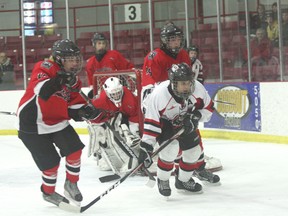 Kenora Bantam AA Thistles clear the front of the net for keeper Brandon Scott in the opening game of the Eastman Bantam AA Hockey League final against Seine River Snipers on Saturday, Feb. 23, 2013.
LLOYD MACK/Daily Miner and News