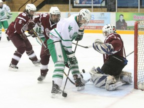 West Ferris Trojan Nick Scott (8) takes the puck to the Algonquin Barons netminder Vincent Demers in the second period.