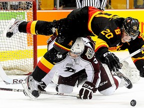 Belleville Bulls forward Tyler Graovac tumbles over Peterborough Petes defenceman Steven Trojanovic during OHL action Saturday night at Yardmen Arena. (Michael J. Brethour for The Intelligencer)