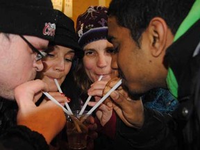 From left, Rodney Jeninga, Elaine Foster, Carolynne Champagne and JoJo Jose share a glass of water they requested from a local restaurant to complete one of the tasks in the Stratford/Perth Shelterlink "Night in the Cold" scavenger hunt Saturday. Laura Cudworth/The Beacon Herald
