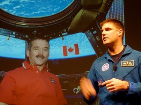 Astronaut Jeremy Hansen from London, Ont. is pictured against screenshot of Canadian astronaut Chris Hadfield during a live 'downlink' chat held at the University of Waterloo, recently. Fellow Sarnia native and university professor Ian McKenzie was instrumental in organizing the event. SUBMITTED PHOTO/FOR THE OBSERVER/QMI AGENCY