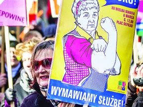 A file picture taken on March 11, 2012 shows Polish feminists holding placards reading “Enough exploitation, we quit!’ during a march of left wing and feminists organizations marking the International Women’s day in Warsaw.