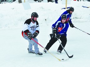 The Austin Aces and Easton Fection battle in the C-side final of the Western Canadian Pond Hockey Championships Sunday in Portage la Prairie. (Kevin Hirschfield/PORTAGE DAILY GRAPHIC/QMI AGENCY)