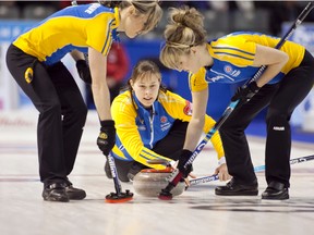 Team Alberta skip Kristie Moore, throws as second Michelle Dykstra and lead Amber Cheveldave sweep during the 2013 Scotties Tournament of Hearts in Kingston, Ontario. (Photo courtesy Andrew Klaver Photography)