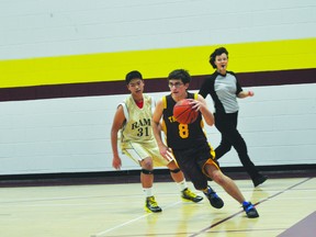 Drew Lambert of the JV Trojans dribbles during a game earlier this year. (Kevin Hirschfield/PORTAGE DAILY GRAPHIC)