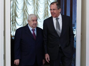 Russia's Foreign Minister Sergei Lavrov (R) and his Syrian counterpart Walid al-Moualem walk into a hall during a meeting in Moscow, February 25, 2013.  (REUTERS/Sergei Karpukhin)