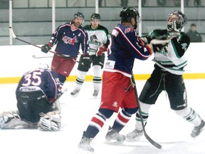 The Ripley Wolves hosted the Elora Rocks in game 2 of their quarter final on Saturday, Feb. 23, 2013. Despite being down 4-1 after the opening period, the Wolves would charge back to win the game by a final of 5-4. Here, Wolf Ryan Armstrong reacts to what looked like a high hit from Brad Woods of the Rock after the whistle had went to call play dead. The chippy play by the Rocks led to a penalty filled third period, which proved to be Elora's undoing as the Wolves scored four unanswered goals to take the win, evening the best of seven at 1-1.