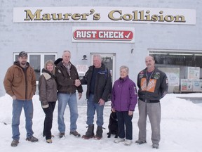 Pictured from left to right: Thane Wootton, Bonnie and Brian Walters, accepting the keys from Paul and Frances Maurer, their pup "Etch" and Larry McCulloch.