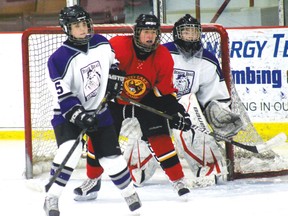 Beaver Brae’s Stephanie Sparkman, Red Lake’s Micah Cabral, and Bronco goalie Becca Mahon wait in front of the Bronco’s net as the other players close in. 
ALAN S. HALE/Daily Miner and News