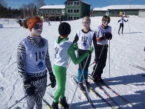 Four young skiers attired as the rock stars KISS prepare for the annual Frank Symonds 10 km Classic cross-country ski race at Mount Evergreen Ski area, Sunday, Feb. 24.