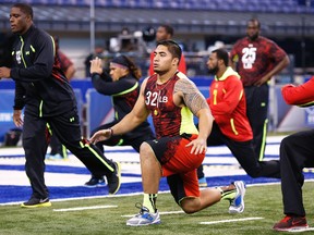 Notre Dame linebacker Manti Te’o stretches before taking part in drills at the NFL combine yesterday. Te’o failed to impress. (GETTY IMAGES)