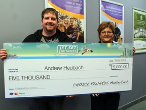 Linda Kitchen-Clark, branch manager in Paris of Your Neighbourhood Credit Union, presents member Andrew Heubach with a cheque for $5,000 as winner of the Jet-set Getaway contest sponsored by CUETS Financial on Friday, Feb. 22, 2013. The money gets Heubach all-expenses-paid trips to two North American cities and the opportunity to donate $2,500 to the charity of his choice. MICHAEL PEELING/The Paris Star/QMI Agency
