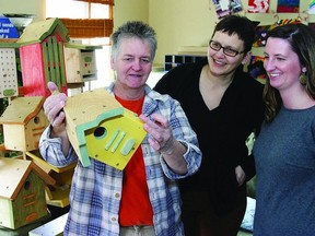 Kym Tyson, (l-r) shows Michelle LeMarche, with Kingston Interval House, and Kim Graham, community education coordinator at the Sexual Assault Centre, some of the bird houses and feeders she will be bringing to the second annual She Creates…One of a Kind Show on Saturday, March 2, from 11 a.m. to 4 p.m., at the Portsmouth Olympic Harbour. The event, held in celebration of International Women’s Week, will showcase over 75 women vendors displaying, selling and demonstrating their art and talents.       Rob Mooy - Kingston This Week