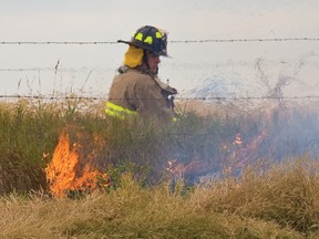 A Firefighter from Rocky View County battles a grassfire near 8th St. and Twp. 264 south of Airdrie Sept. 21. 
JAMES EMERY/AIRDRIE ECHO FILE PHOTO