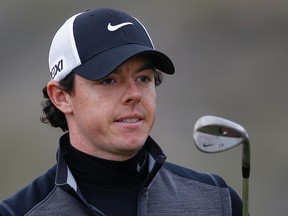 Northern Ireland's Rory McIlroy holds up his club on the eighth hole against Ireland's Shane Lowry during the weather delayed first round of the WGC-Accenture Match Play Championship golf tournament in Marana, Ariz. Feb. 21, 2013. (REUTERS/Matt Sullivan)