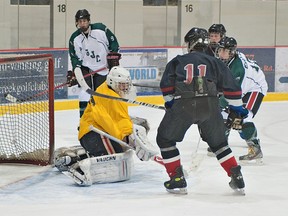 BRIAN THOMPSON, The Expositor

Evan Bidenti (right) of St. John's College watches his shot beat Assumption goalie Austin Hill during a high school boys hockey game Tuesday at the civic centre.