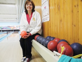 Helene Gilmore, fundraising committee member, ties her bowling shoes to prepare for the sixth annual Rock and Bowl for CHEO and silent auction which takes place this Saturday at Nativity Bowl.
Staff photo/ERIKA GLASBERG