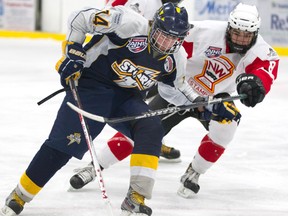 The Storm’s Bailey Gagne keeps the puck out of the reach of Calgary’s Phelan Shaw as the Grande Prairie U-16 Boston Pizza Storm took on the Calgary AAA Midget Stamps at the Coca-Cola Centre Saturday evening. The Storm won 5-2. (Randy Vanderveen/Special to the Daily Herald-Tribune)