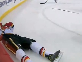 Matt Stajan lies prone on the ice at the Excel Energy Center in St. Paul, Minn. Tuesday, Feb. 26, 2013. He was on the receiving end of a Charlie Coyle elbow. (Screengrab)