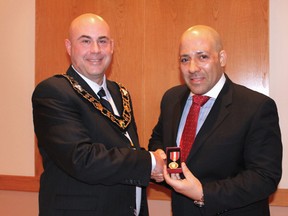 Huron-Kinloss Mayor Mitch Twolan (left) presents the Queen Elizabeth II Diamond Jubilee Medal to David Mathews at Ripley council chambers on Feb. 19.