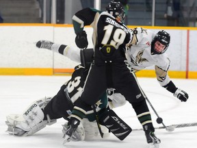 Quinte West Major Midget Hawks' Cameron Sager slams into Uxbridge Stars' goalie Jake Joosten and then bangs in the loose puck as the Hawks routed the Stars 7-2 Saturday at the Community Gardens. The Hawks also beat the Stars 3-1 Sunday to advance to the OMHA semi-finals.