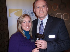 Sarah Callow of Chatham presents Chris Appleton, newly-elected chair of the Chatham-Kent Chamber of Commerce, with a gavel following the organization's annual general meeting Wednesday at Smitty's Restaurant. Callow is a newly-elected director of the chamber. (BOB BOUGHNER, Chatham Daily News)