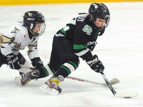 Quinte West Calderwood Automation Novice Hawks' Nathan Bassett trips up Cobourg Cougars' Liam Filip during the Hawks' 4-0 win Sunday at the Community Gardens.