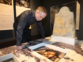 Government of Alberta Head of Archaelogy looks at the John Hartnell grave display with a replica grave marker at the new Arctic 4 exhibit at the Royal Alberta Museum in Edmonton, Alberta on Feb 20, 2013. 

Perry Mah/QMI Agency