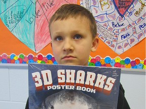 Students buy books
Tyson Godwin, a six-year-old, Grade 1, Sangudo Community School student, shows, 3-D Sharks, the book he bought at the school's Scholastic Book Fair on Wednesday, Feb. 27. The event was held through the first four days of the week. Tyson said he enjoys reading.