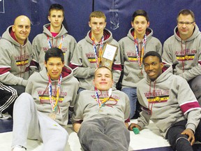 The Sabres wrestling team poses with their medals and second mplace plaque at the ASAA Rural Provincial Wrestling Championships.