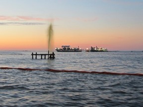 An inactive wellhead owned by Swift Energy is seen discharging an oily-watery mixture after being struck by a boat off the coast of Port Sulphur, Louisiana February 26, 2013.  REUTERS/U.S. Coast Guard/Handout