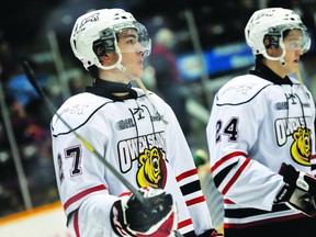 The Owen Sound Attack's Zach Nastasiuk, left, and Chris Bigras line up prior to a game against the Barrie Colts during the 2013-14 season. MARK WANZEL PHOTO