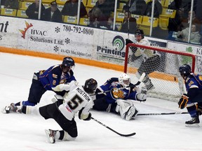 Oil Barons netminder Tanner Jaillet gets just enough of a shot by Bonnyville Pontiacs Mostrom, to tip the shot wide of the net during the second period of Wednesday night’s game between the Barons and Pontiacs at the Casman Centre.  TREVOR HOWLETT/TODAY STAFF