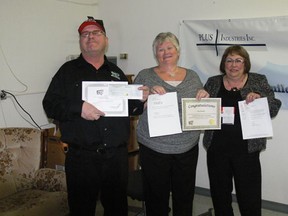 (L to R) Garry Bradley, Judy Childs and Pat Bladen show off the many prizes Bradley was presented with on Tuesday, February 26 at PLUS Industries in Melfort