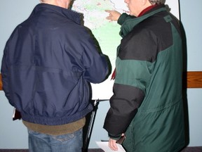Alan Clark, Left, and Greg Riddler talk over the details of the Algonquin land claim at a public information meeting, Wednesday, Feb. 27, 2013, at the North Bay Legion. Almost 300 people packed the hall.
