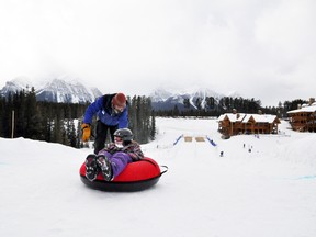 Ski and snowboard school instructor Greg Dunlop gives young skier Jessica Heidel the Super Tornado Spin down the newly opened Sunny Tube Park at the Lake Louise Ski Area on Friday. 
Corrie DiManno/ Banff Crag & Canyon