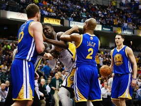 Indiana Pacers centre Roy Hibbert (2nd L) shoves Golden State Warriors forward David Lee (L) while Warriors guards Jarrett Jack (2) and Klay Thompson (R) stand near the play during their NBA basketball game in Indianapolis, Indiana February 26, 2013. Hibbert was called for two technical fouls on the play and ejected from the game.  (REUTERS)