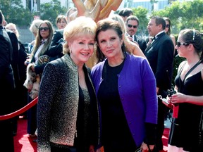 Debbie Reynolds, left, has assured fans daughter Carrie Fisher is "doing exceptionally well" following her psychiatric breakdown last week. (Nikki Nelson/WENN.COM)