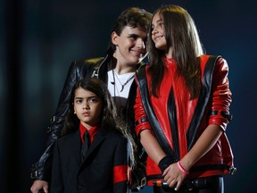Michael Jackson's children (L-R) Blanket, Prince and Paris stand on stage during the "Michael Forever" tribute concert, which honours late pop icon Michael Jackson, at the Millennium Stadium in Cardiff, Wales October 8, 2011. REUTERS/Eddie Keogh