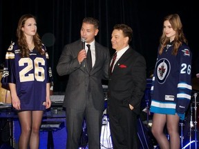 Past president of the Sons of Italy, Justin Bova, and entertainer Steve Lippia, are joined by a couple of models as they address the audience at the 2012 gala dinner, which raised $100,000 for Winnipeg Harvest. (HANDOUT PHOTO)