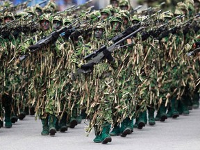 Sri Lankan army snipers march during a parade marking the anniversary of the defeat of the Tamil Tigers and the end of a quarter-century of civil war. But since the war's end, rather than presiding over a period of peace and reconciliation as hoped for by the international community, the governing regime has become increasingly authoritarian.