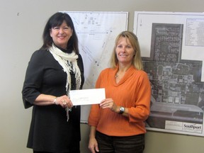 Southport CEO Peggy May gives a cheque for $1,000 to Tracy Waldvogel of the BDO Centre for the Community, Thursday. The funds will be used to address repairs for the roof which need to be done soon. (ROBIN DUDGEON/PORTAGE DAILY GRAPHIC/QMI AGENCY)