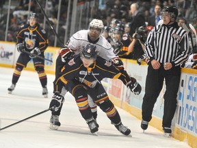 Brendan Lemieux of the Barrie Colts ducks under Gemel Smith of the Owen Sound Attack during first period action Thursday at the Barrie Molson Centre.