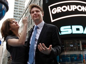 Groupon CEO Andrew Mason poses with his newly married wife, pop musician Jenny Gillespie, outside the Nasdaq Market following his company's IPO in New York in this file photo taken November 4, 2011. (REUTERS/Brendan McDermid/Files)