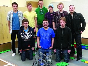 ABJ’s VEX Robotics team stands with their latest robot.