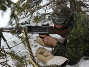 Corporal Jessie-Leigh Kezar stationed behind a C-6 General Purpose Machine Gun at his observation post in Island Falls during Exercise TRILLIUM RESPONSE 13.